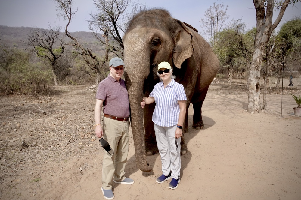 Travelers and the elephant at the Dera Amer sanctuary in India.