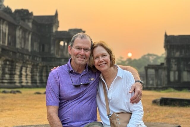 Travelers Mike and Lindsay Lanaux during sunrise at Angkor Wat, Cambodia.