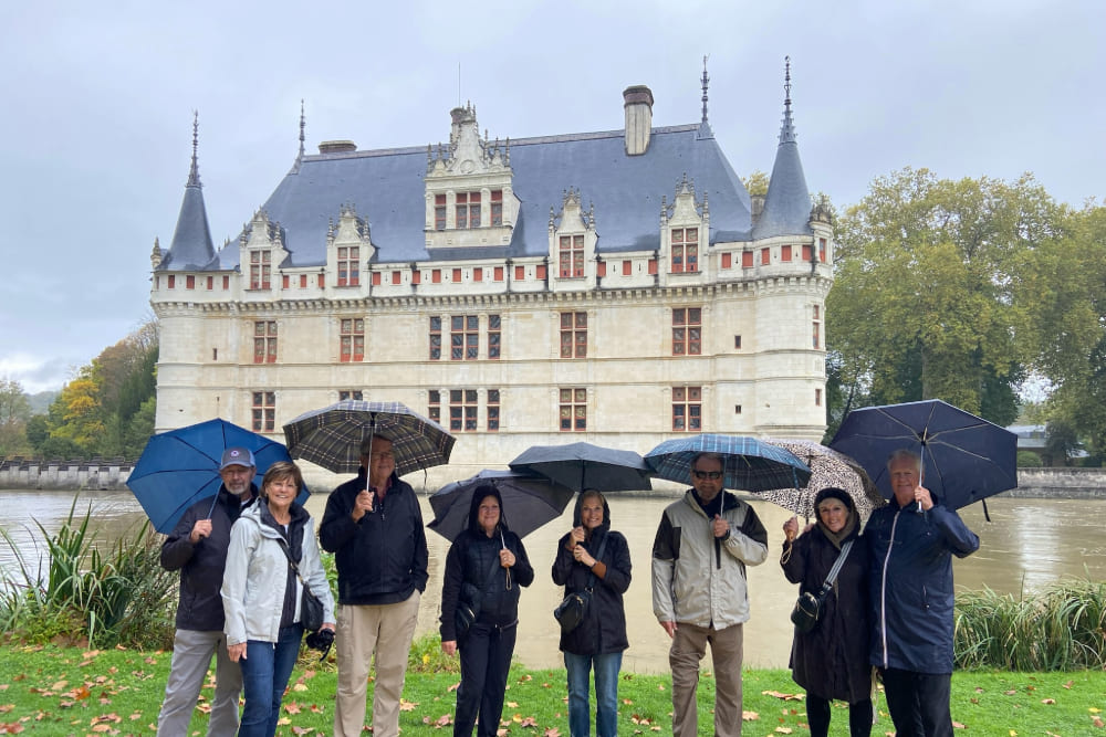 Kristy Trask and friends posing next to a castle in France.