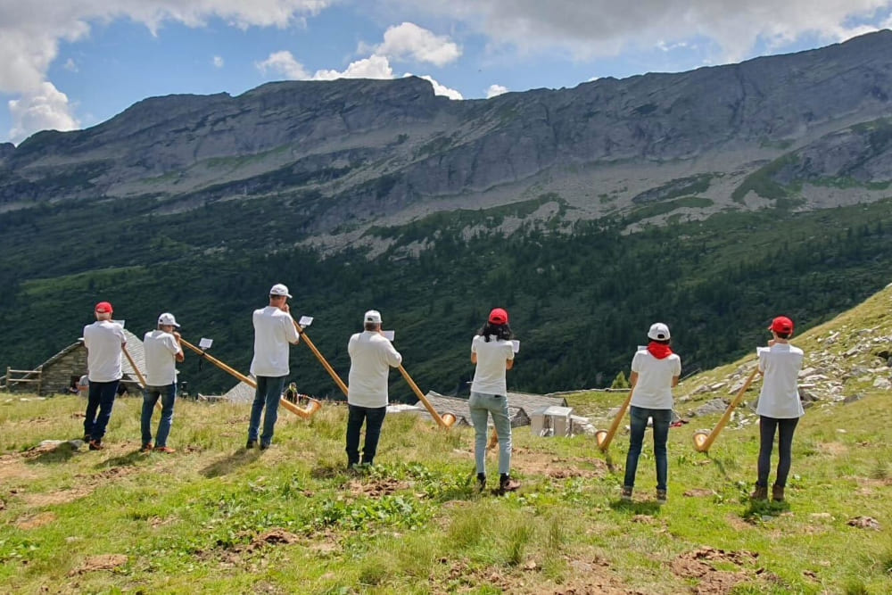 Musicians playing alpine horn during a celebration in Switzerland.
