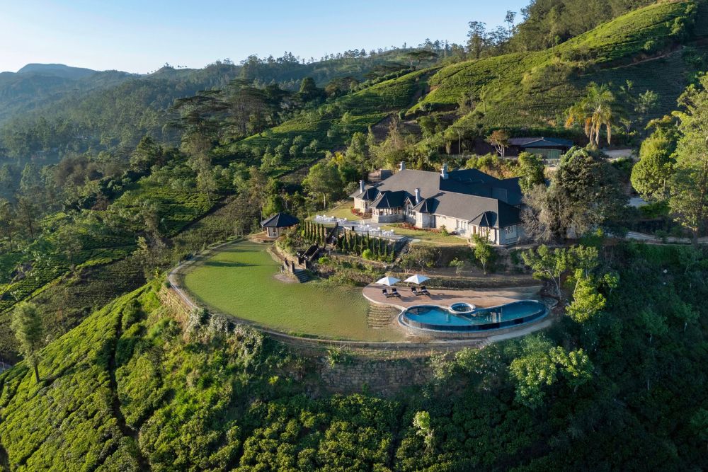 Aerial view of Uga Halloowella hotel surrounded by tea terraces in Sri Lanka. 