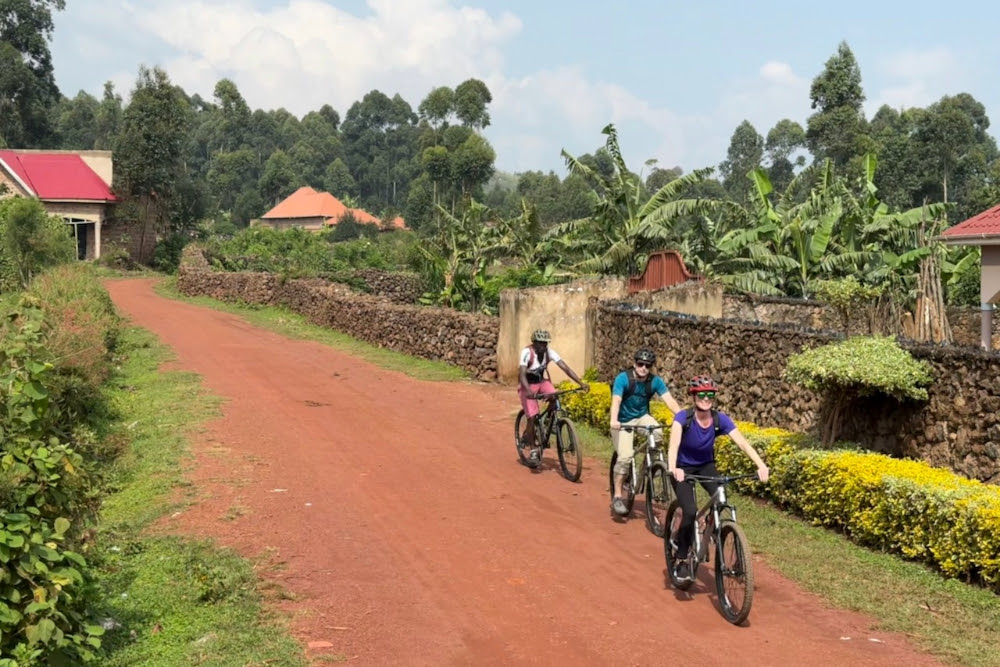 Brook Wilkinson riding a bike in Uganda.