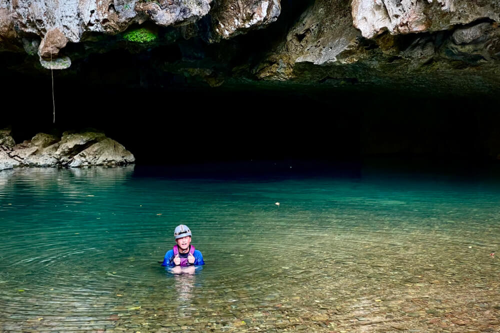 Chris Kloes' son swimming in a cave in Belize.