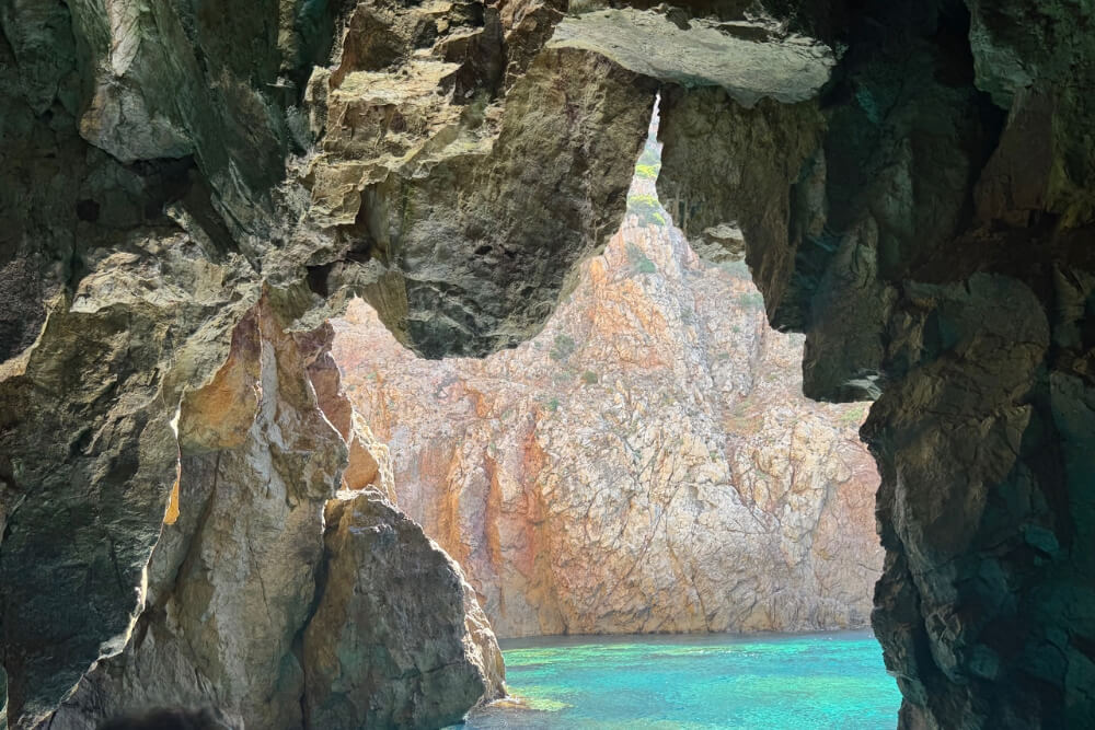 Grotto in Sardinia, Italy with aqua blue water.