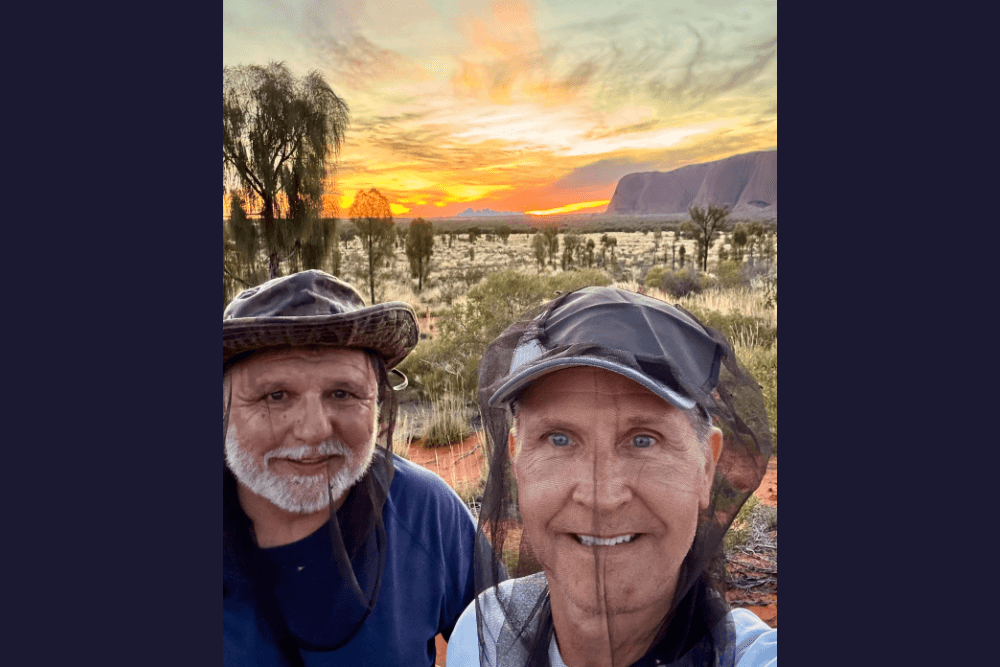Travelers Stan and Jay at Uluru during sunset.