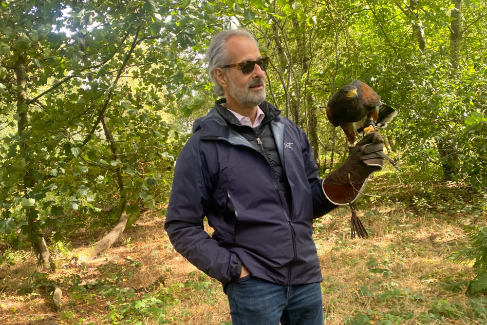 Adam Amsterdam holding a falcon at The Gleneagles Falconry School in Scotland.