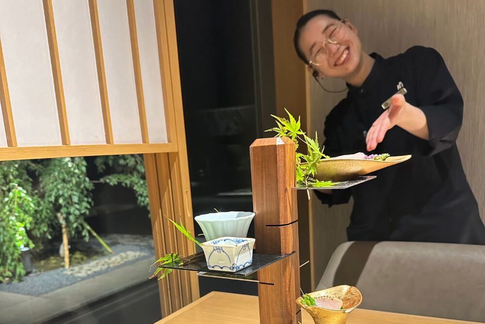 A server bringing dinner in a traditional ryokan in Hakone, Japan.