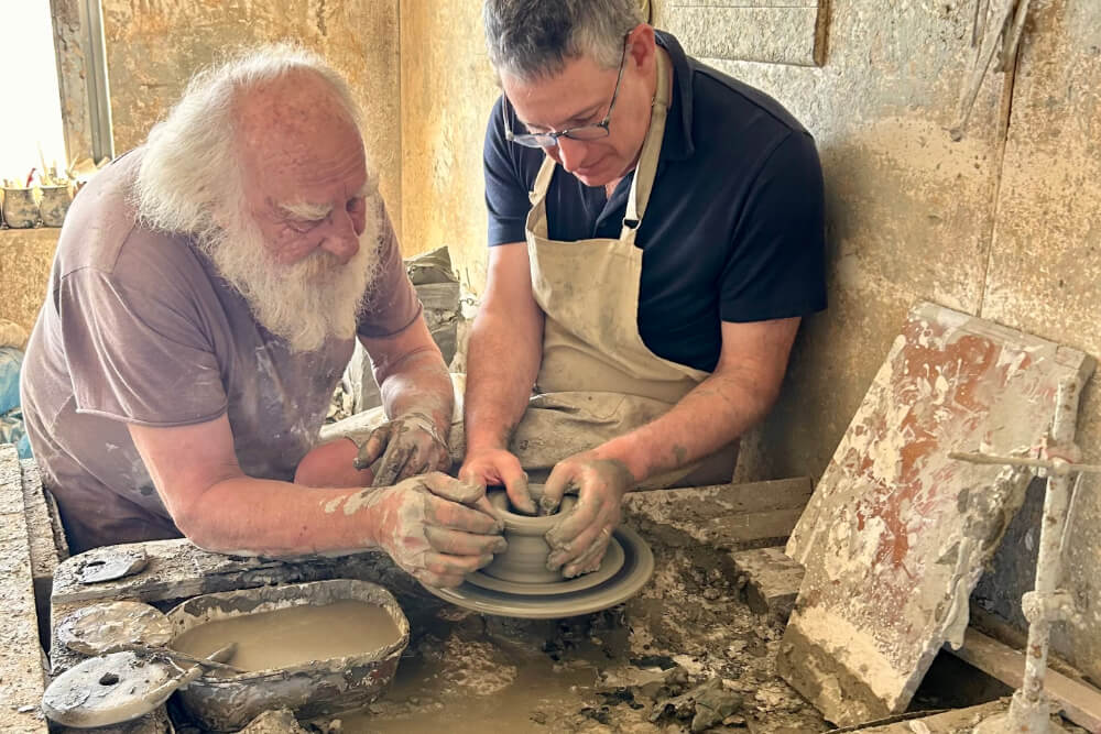 Jonathan Scharfstein and a master potter during a private workshop in Santorini, Greece.