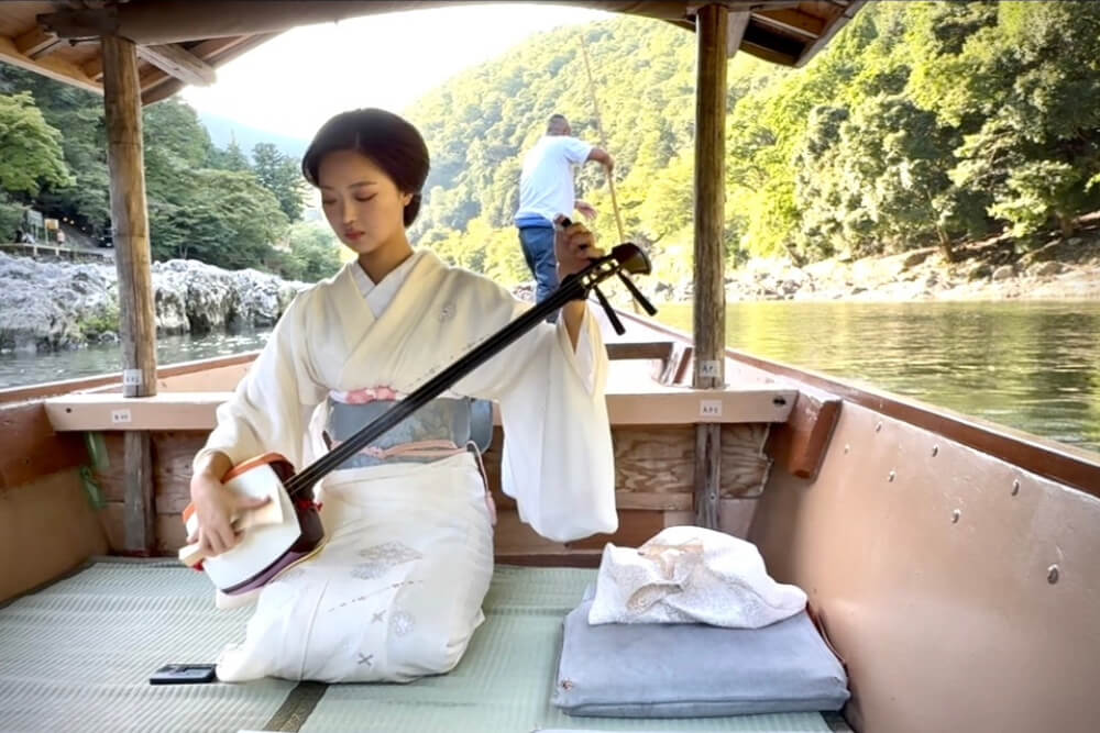 An intimate shamisen performance by a former Maiko on a boat, in Japan.