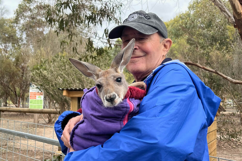 Lori Siegel’s travel companion with a young kangaroo.