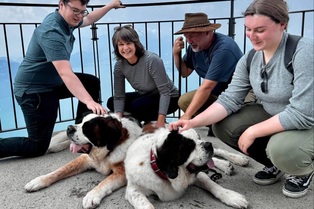 Sharon Kornhaus and family with two St. Bernard dogs, overlooking Lake Lucerne in Switzerland.