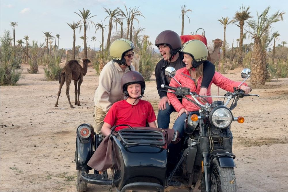 Brook Wilkinson and family riding a sidecar motorcycle in Marrakech, Morocco.