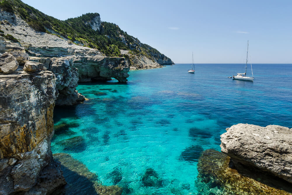 Blue water and cliffs on Antipaxos Island, Greece.