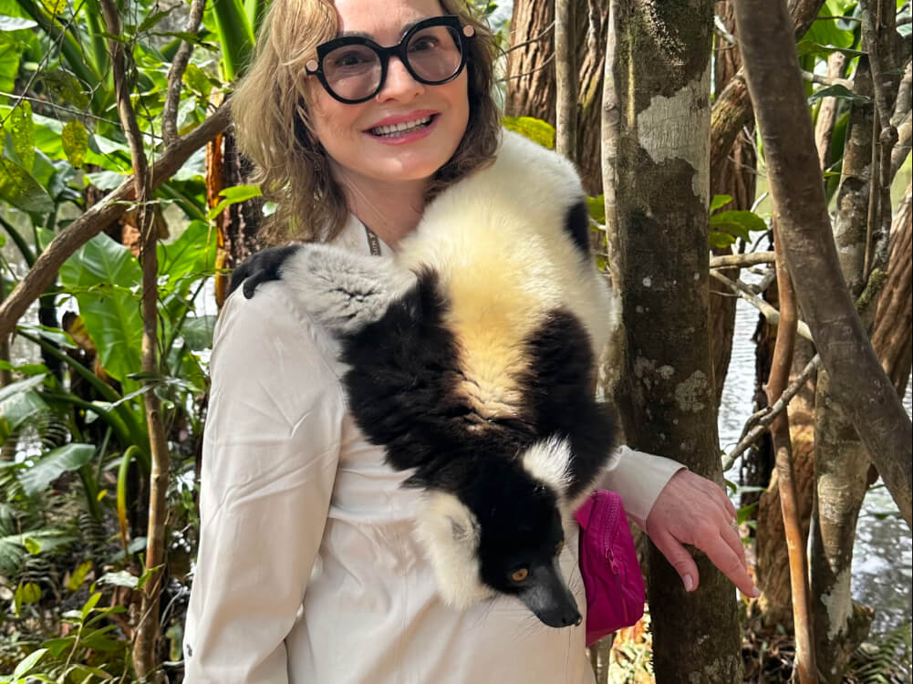 Katherine Montgomery holding a lemur at Vakona Private Reserve in Andasibe, Madagascar.