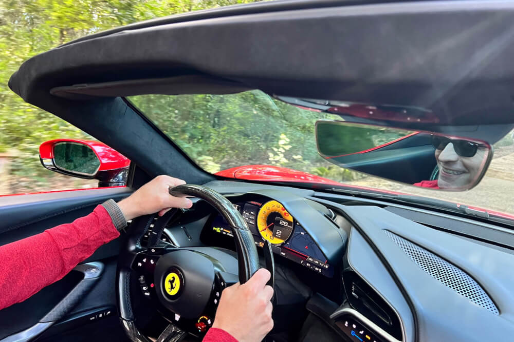 Michael Ruma driving a Ferrari in Italy.