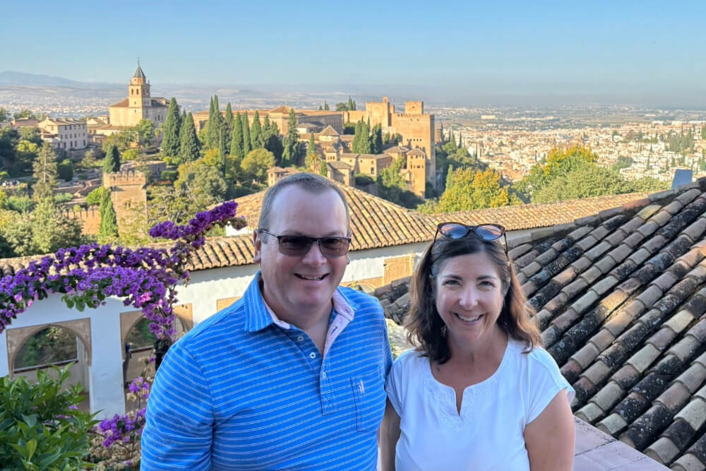 Susan Gosselin and her husband touring the Generalife, with the Alhambra and Granada in the background.