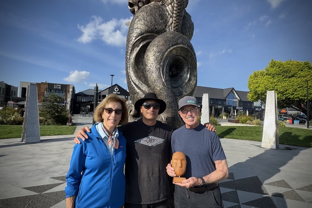 Karen Lindfors and Patrick Moore with a Maori master carver and the hand-carved mask he gave them.