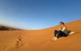 Susan Crandell sandboarding in the Sahara dessert in Morocco.