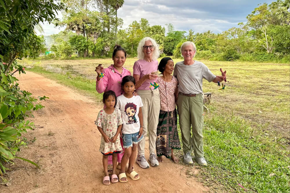 Janet Eustis and her husband Dick with the family of their origami teachers in Siem Reap, Cambodia.