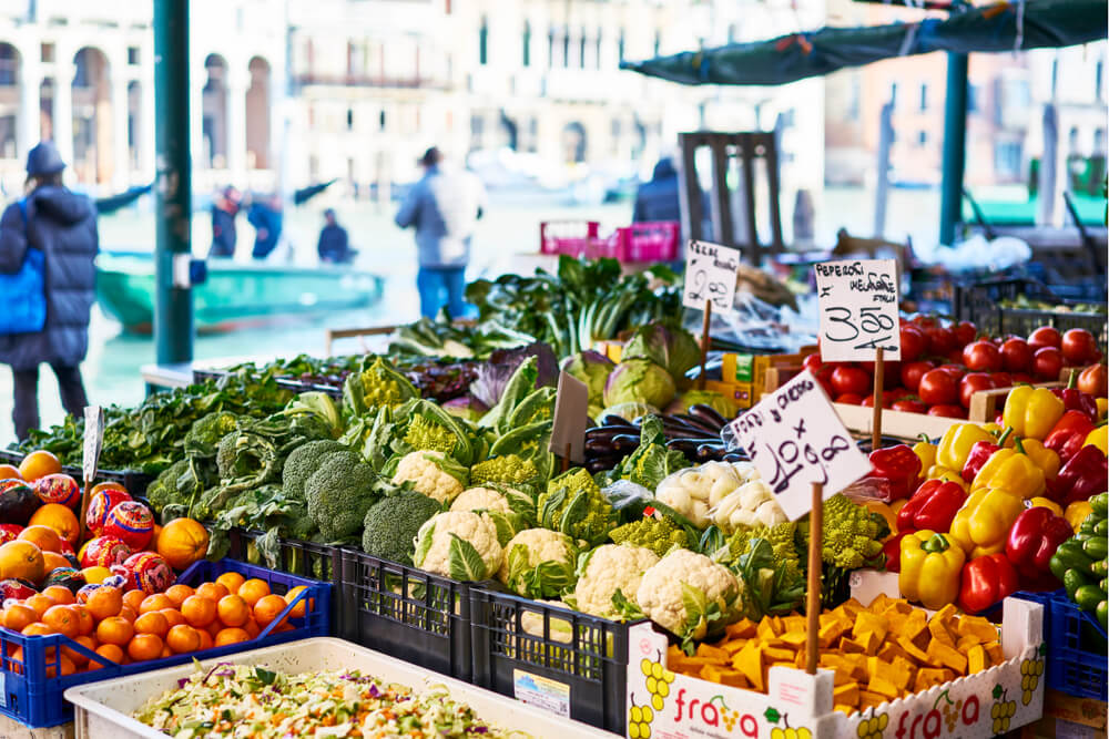 A stall with fruit and vegetables at Rialto Market in Venice, Italy.