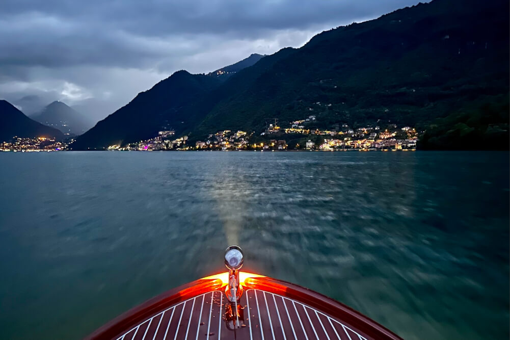 A view of Lake Como from a boat at night.
