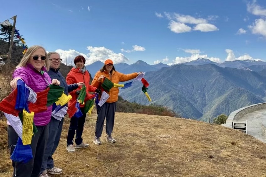 Peggy Murphy with her trip companions behind Jangchub Chorten at Chelela Pass in Bhutan.