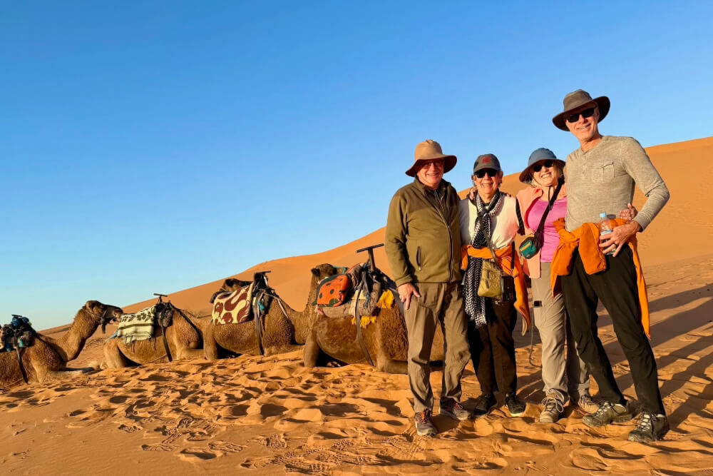 Brian Branagan and wife Rissa Sanchez during a sunset camel ride in the Sahara Desert.