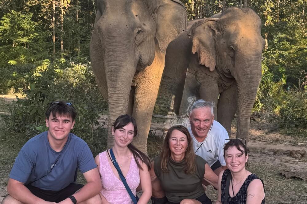 Diane Keenley and family posing with two elephants on Laos.
