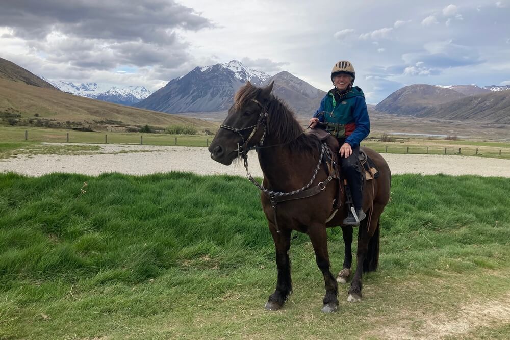 Lois Maltais horseback riding in New Zealand.