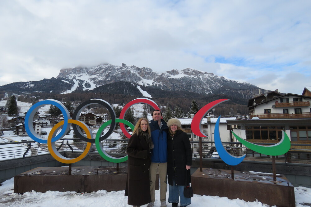 Lynn, Thomas, and Clare Casper posing by the Olympic rings in Cortina d’Ampezzo, Switzerland.