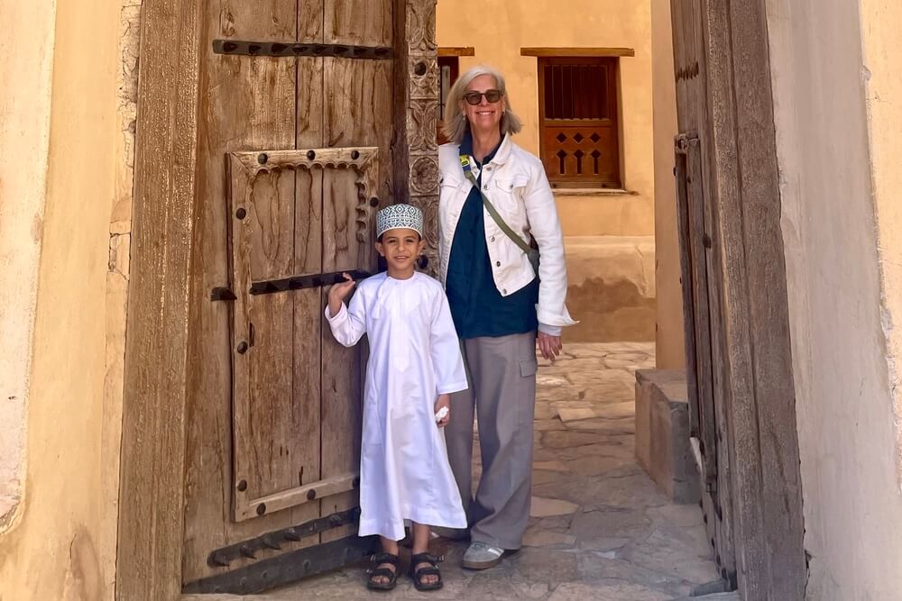 Milinda Martin and a local boy in Nizwa Fort, Oman.