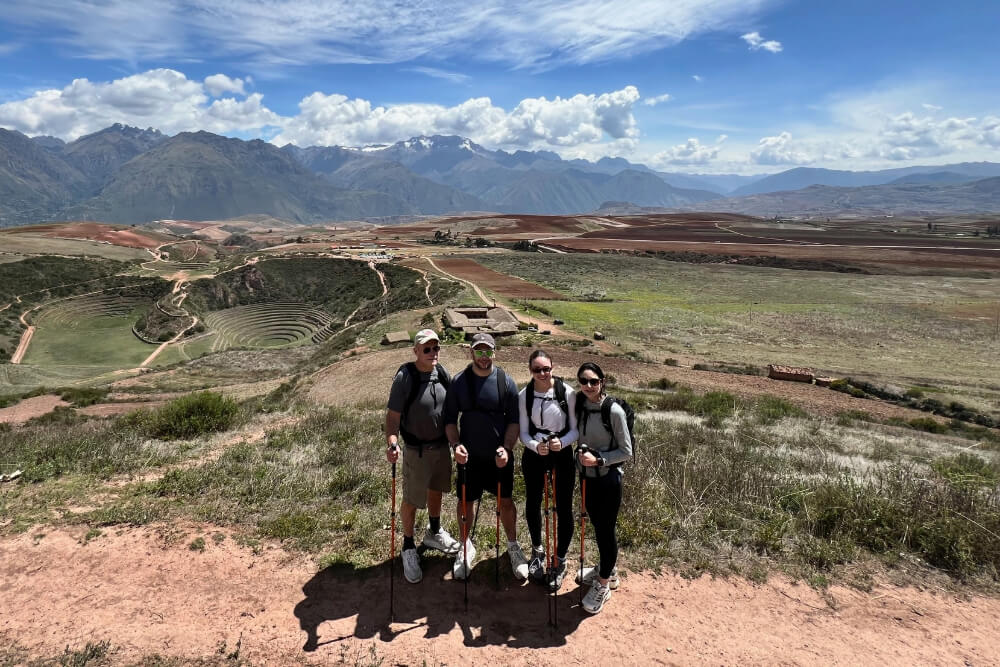 Stacey Witz and her family hiking with panoramic views of Incan ruins in the Sacred Valley, Peru.