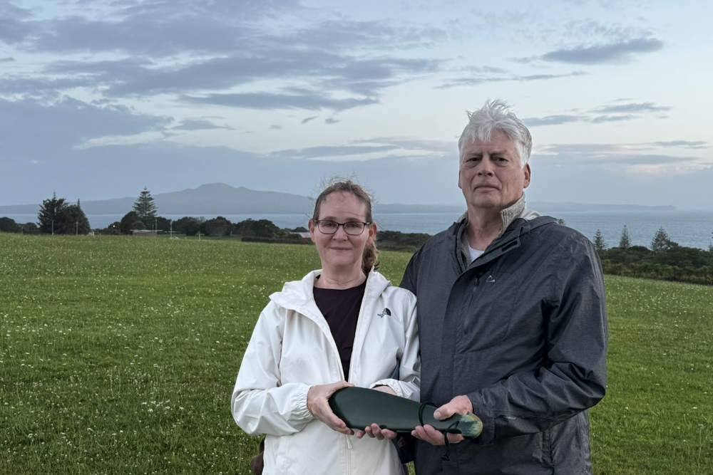 Patrice and Peter holding a sacred greenstone used in the morning ceremony and blessing in Auckland, New Zealand.