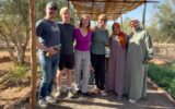 Brook Wilkinson and family with locals during olive picking in Morocco.