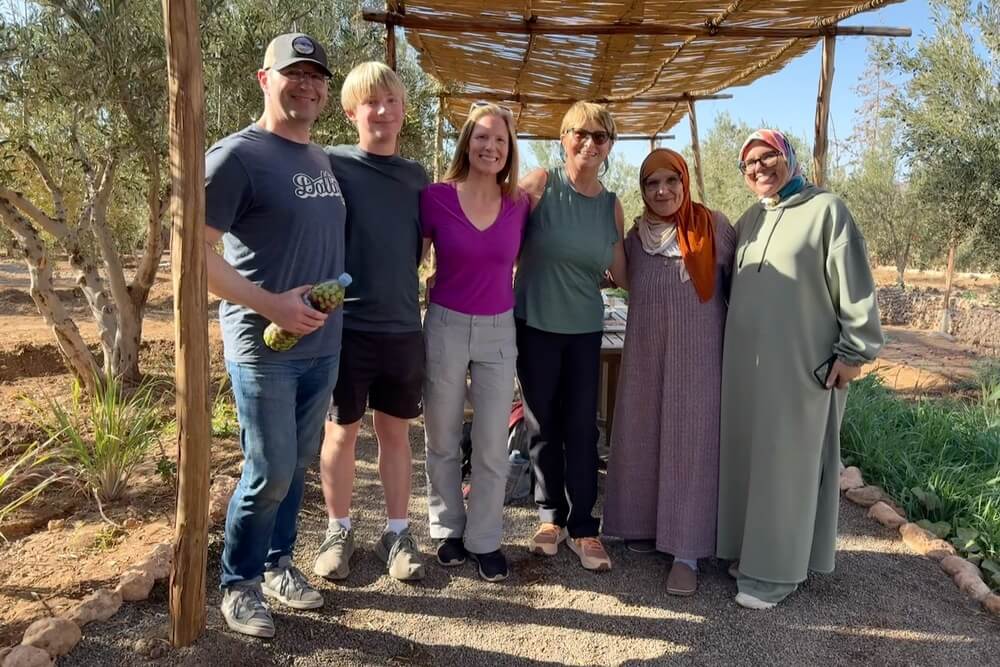 Brook Wilkinson and family with locals during olive picking in Morocco.