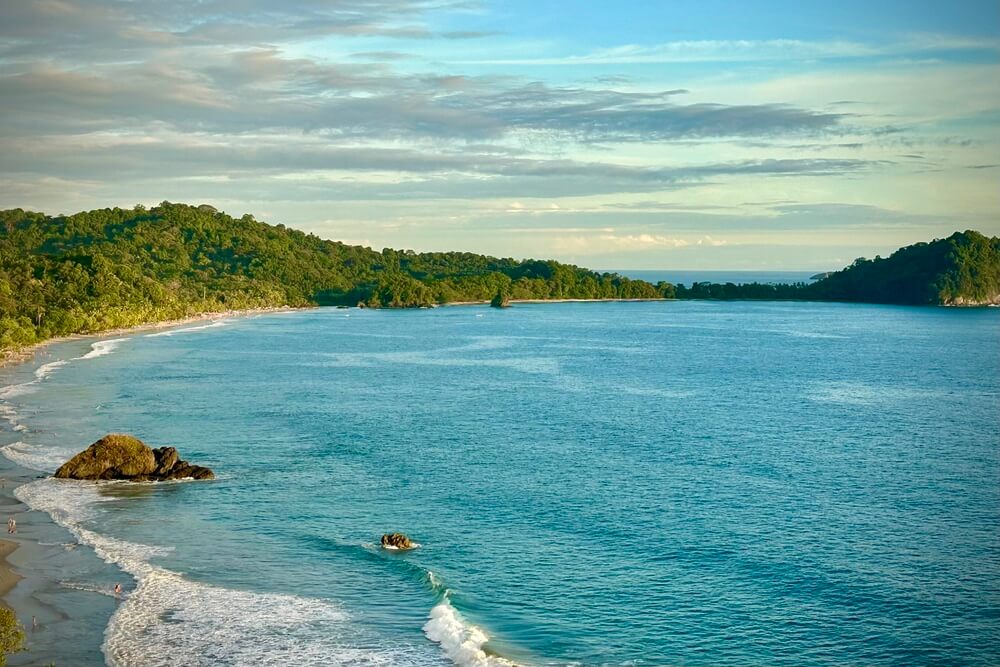 View of a beach from the hotel balcony at Arenas Del Mar in Manuel Antonio.