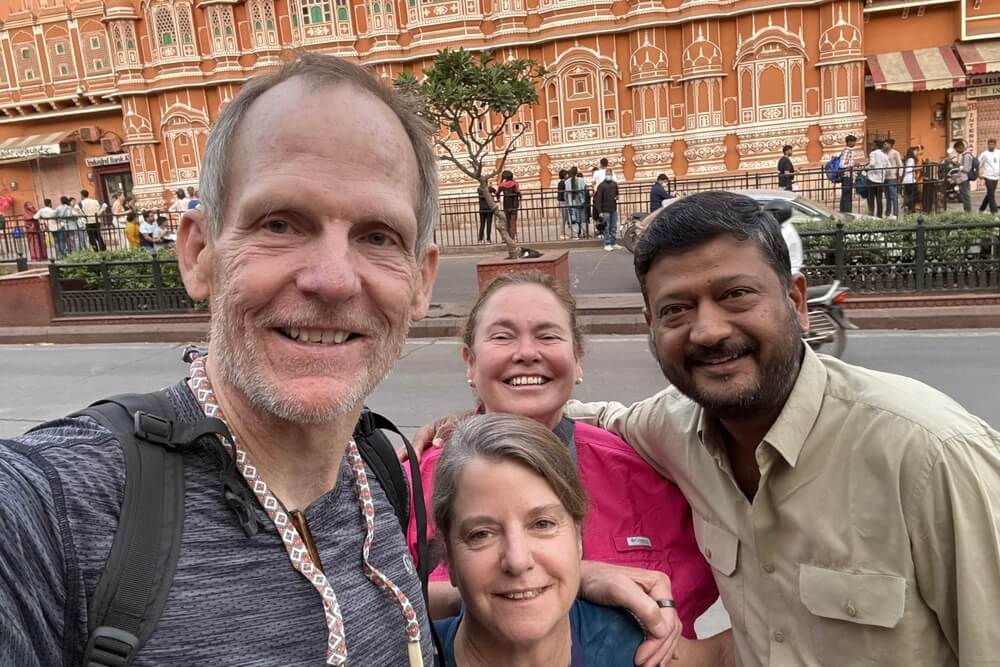 Dan Spears, Gretchen Jacobsen, and Peggy Williams with VJ at the Palace of Winds in Jaipur, India.