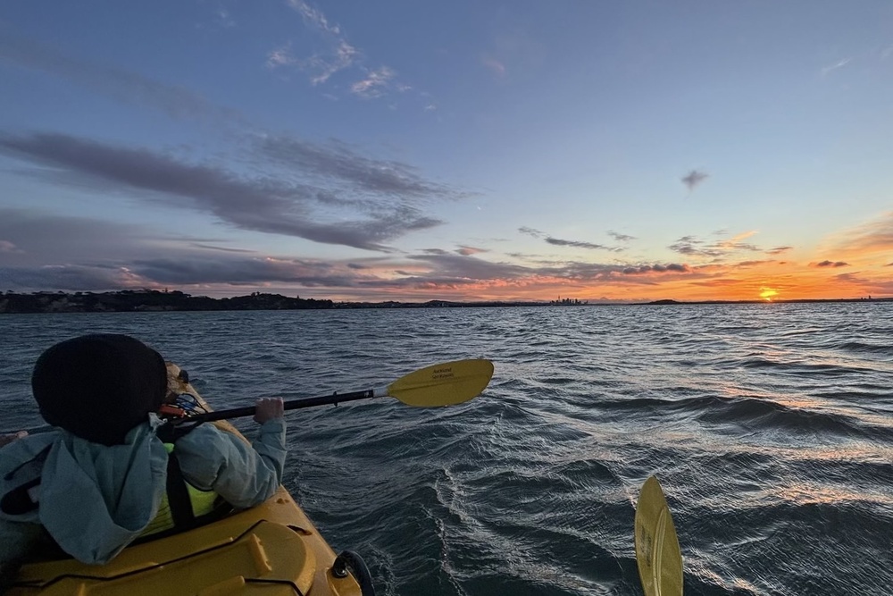 Kathy Giannangelo kayaking at twilight from St. Heliers Bay to Motukorea Island in New Zealand.