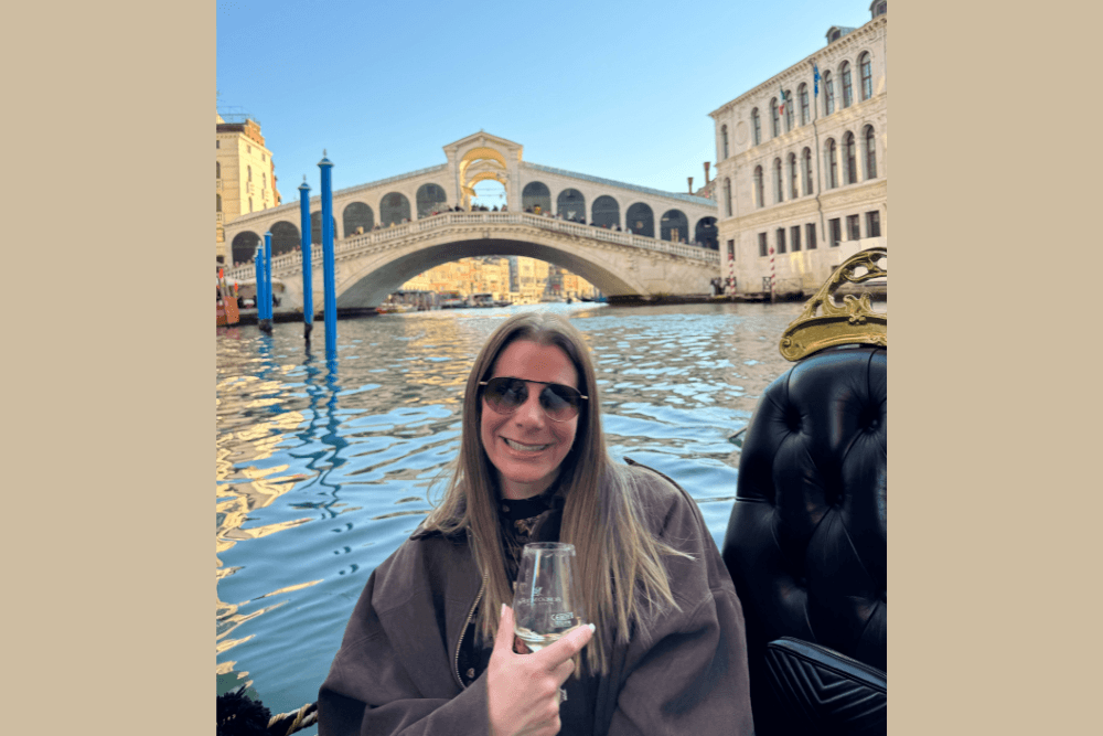 Lauren Schor having a glass of prosecco on a gondola on Venice’s Grand Canal.
