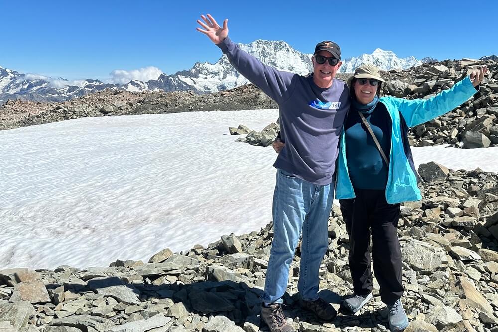 Paul and Ada Kinscherff hiking in the snow in New Zealand.
