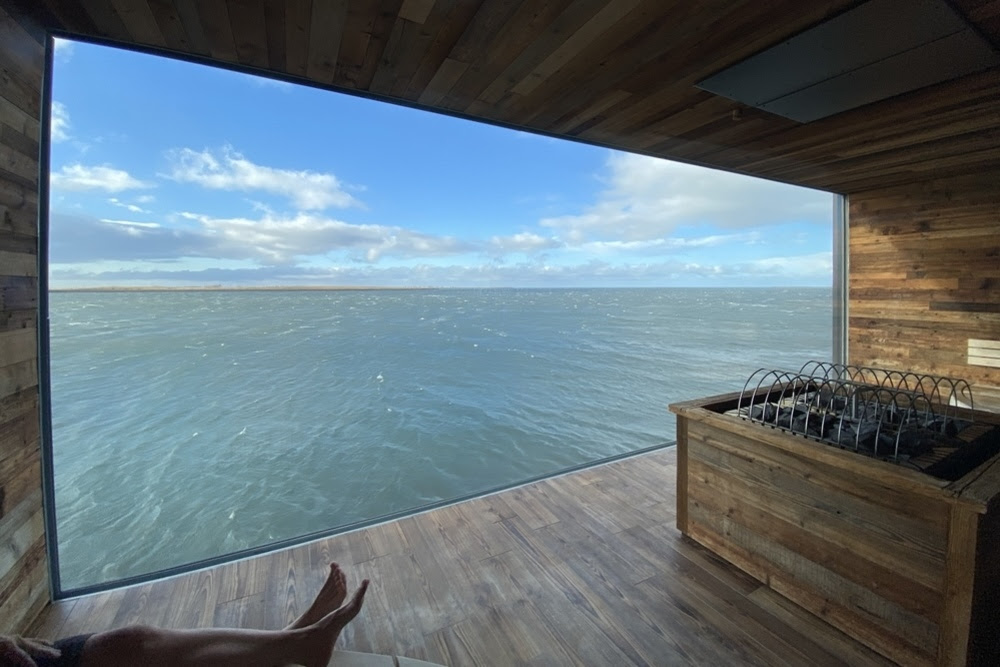 Window at Sky Lagoon sauna with a view of Reykjavik Harbour.