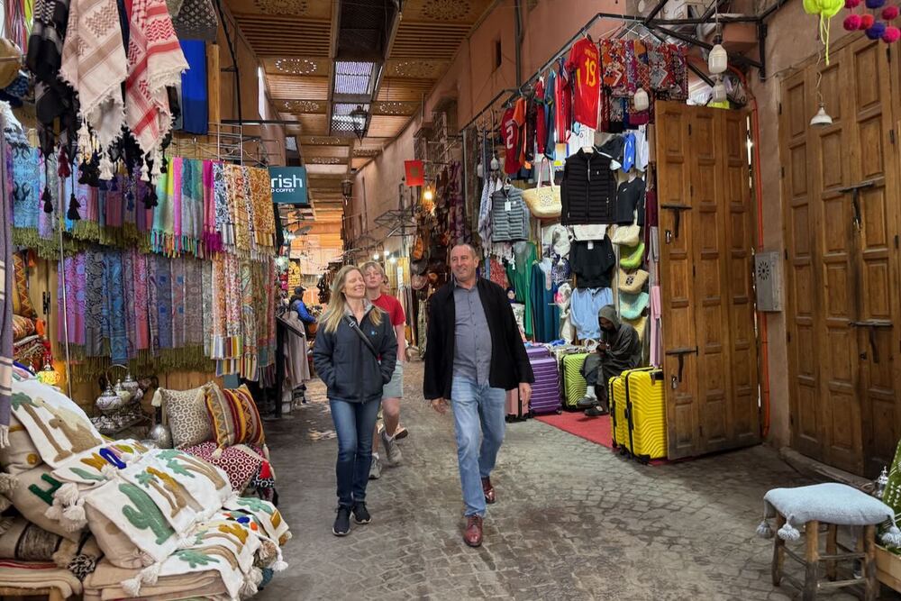 Brook Wilkinson walking with a guide through the Medina market in Marrakech, Morocco.