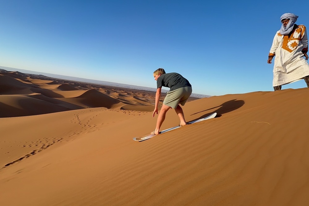 Zeke Damm sandboarding in the Sahara Desert, Morocco.