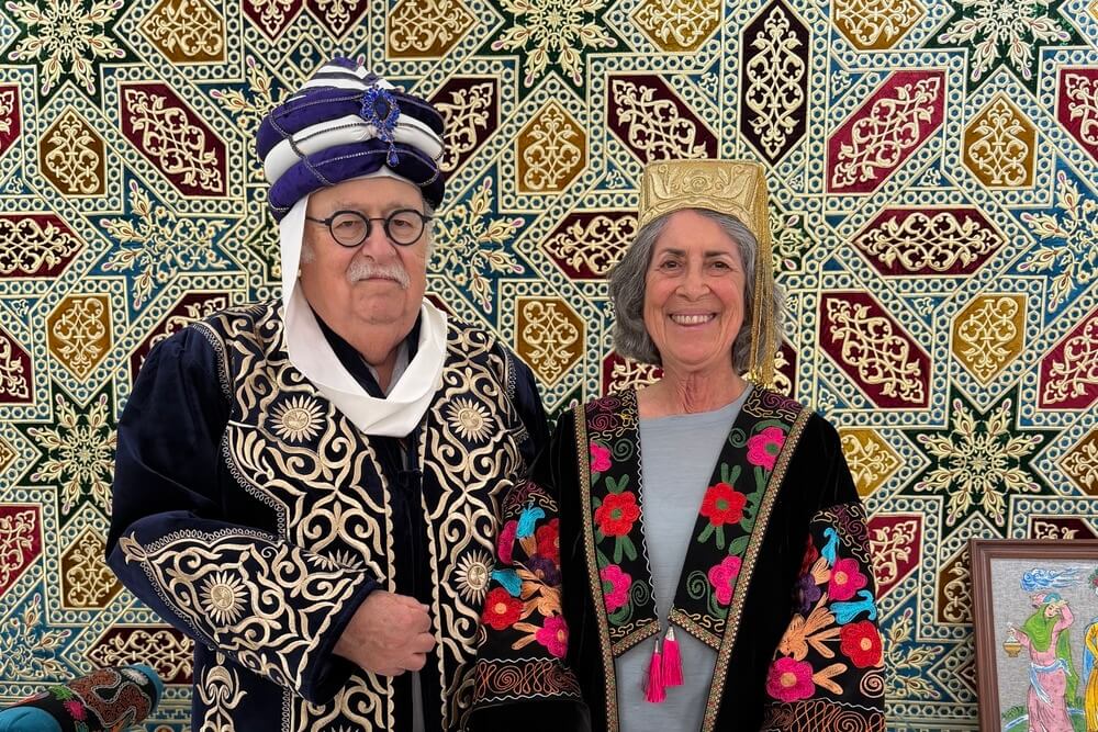Ashley Brown and Edy Netter wearing traditional clothing in a Bukhara, Uzbekistan.