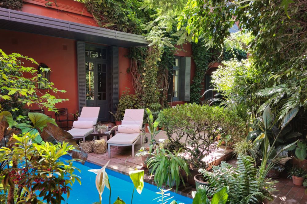 The pool outside the Jardín Escondido hotel surrounded by greenery, Buenos Aires, Argentina.
