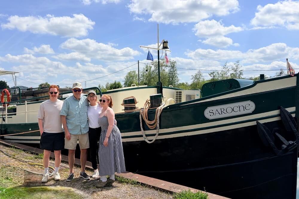 Mary Gaffney, Geoff Miller, and family next to "Saroche" barge cruise boat in Champagne, France.