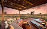 Natural Selection safari lodge deck with plunge pool overlooking Botswana’s wetlands at sunset.