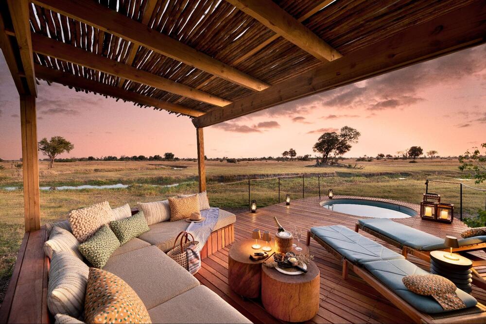 Natural Selection safari lodge deck with plunge pool overlooking Botswana’s wetlands at sunset.