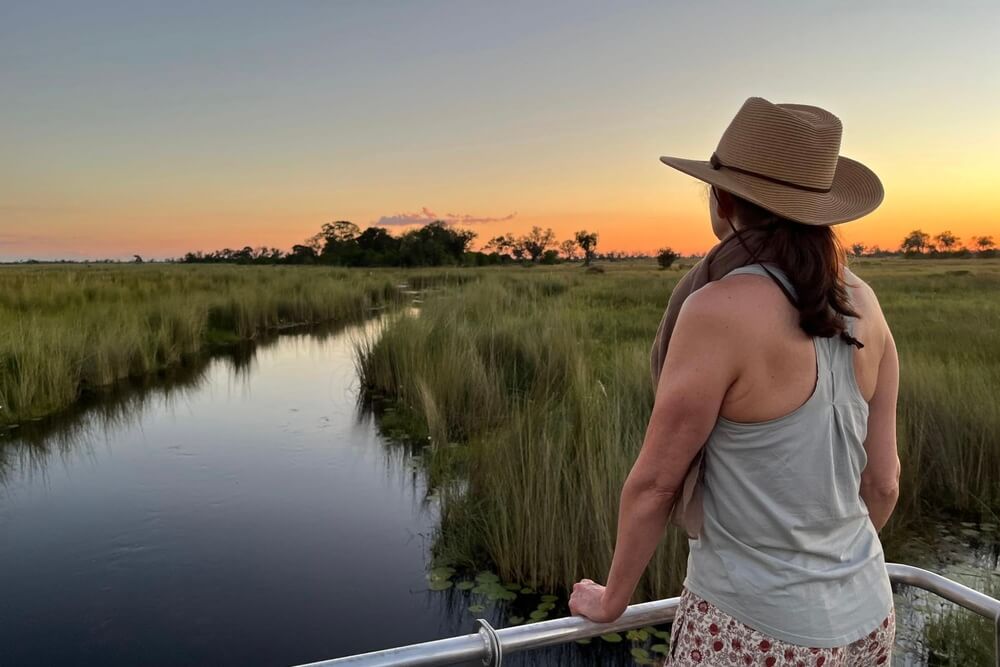 Nichole Bernier overlooking the Okavango Delta at sunset in Botswana.