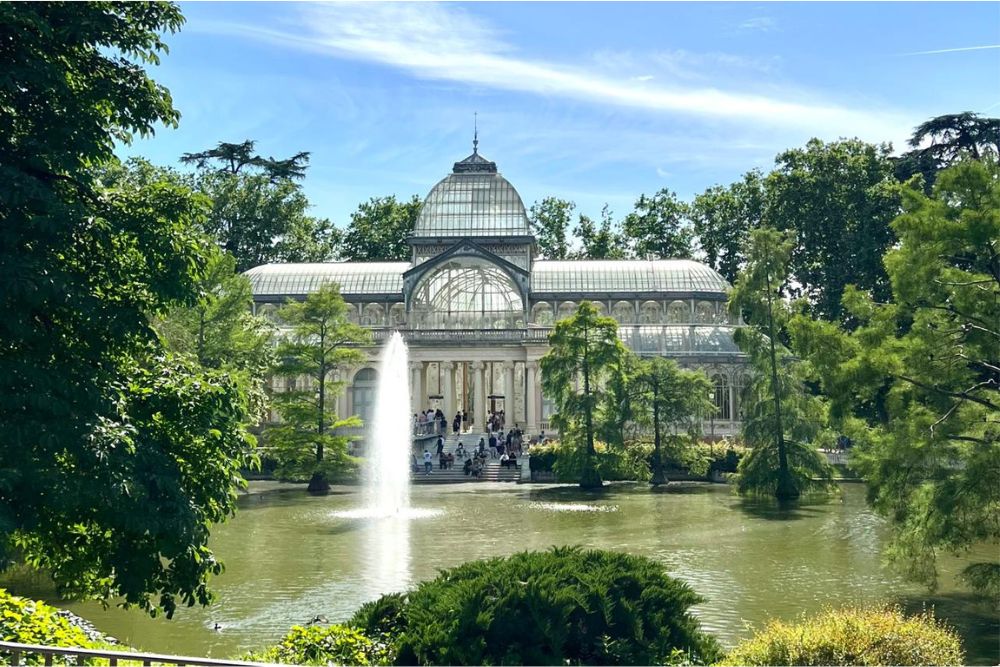 The Crystal Palace and a small lake in El Retiro Park, Madrid.